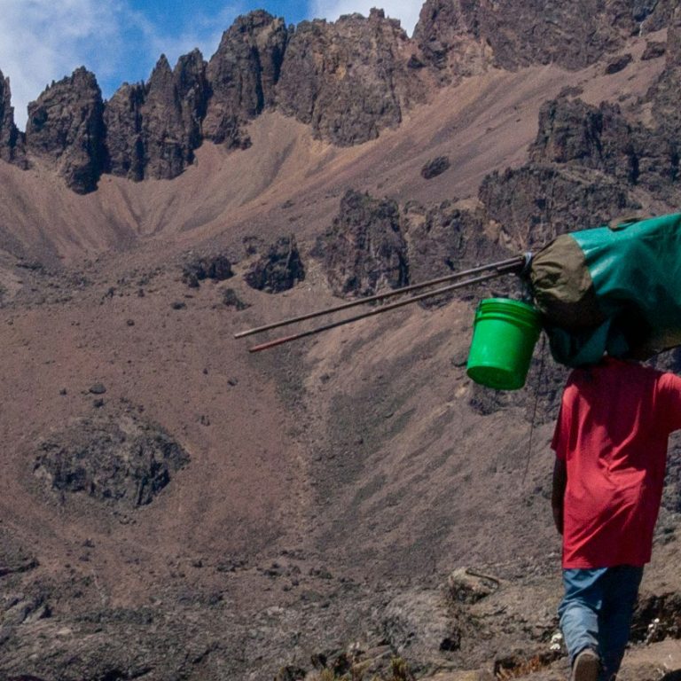 Trekkers climbing Mount Kilimanjaro through scenic mountain route