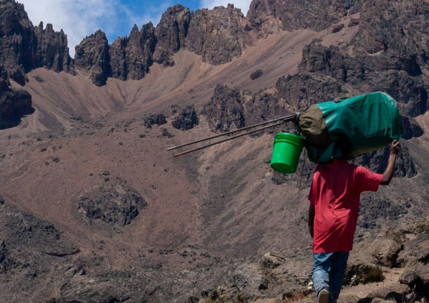 Trekkers climbing Mount Kilimanjaro through scenic mountain route