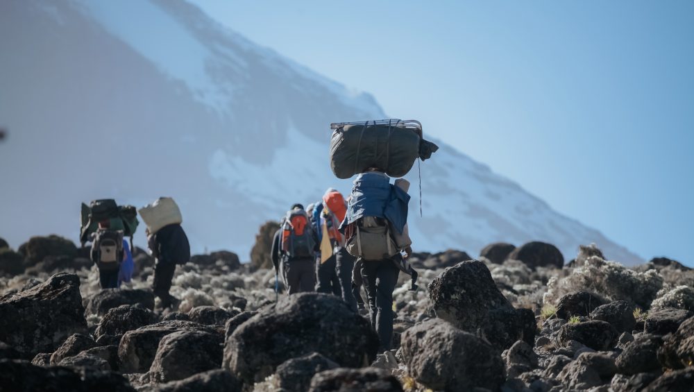 How to Climbing Kilimanjaro without Exploiting the Porters showing ethical trekking support team on Mount Kilimanjaro