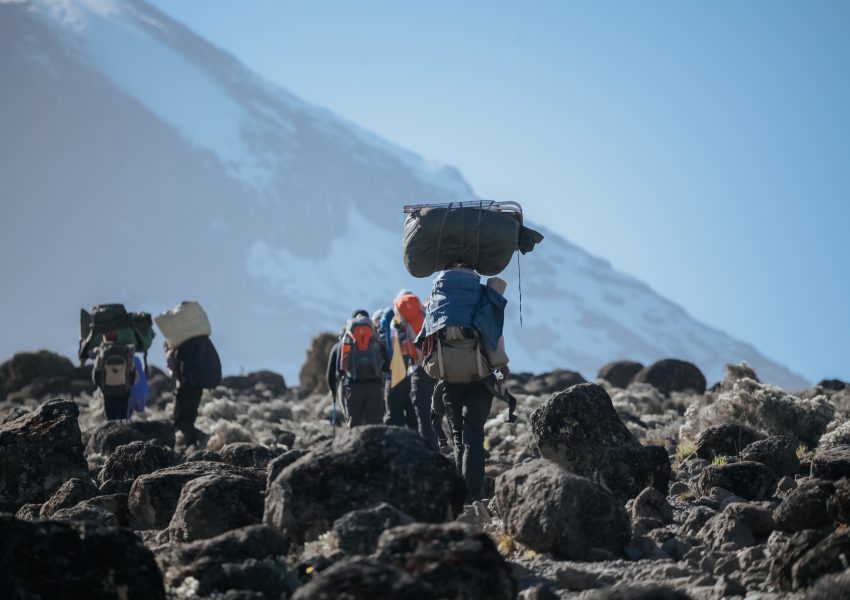How to Climbing Kilimanjaro without Exploiting the Porters showing ethical trekking support team on Mount Kilimanjaro