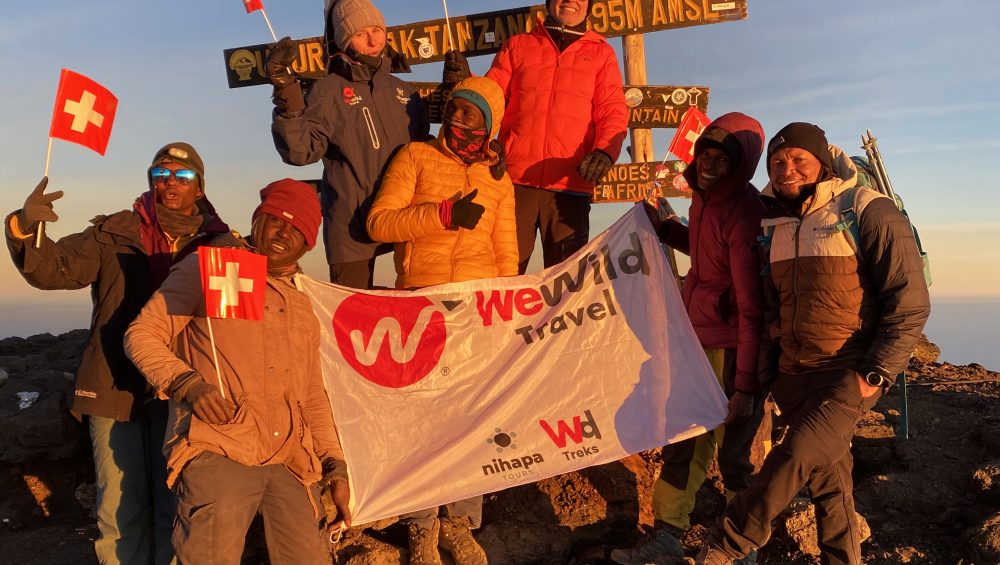 Hikers reaching the summit after trekking the Machame Route on Mount Kilimanjaro