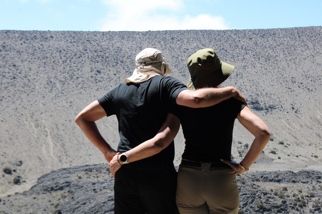 Honeymoon travelers enjoying a romantic Kilimanjaro adventure surrounded by Tanzania’s mountain scenery.