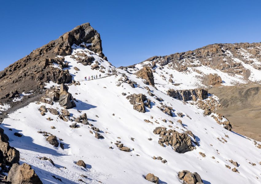 People asking common questions before climbing Mount Kilimanjaro adventure preparation guide