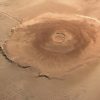 Illustration of Olympus Mons on Mars showing the tallest volcano in the Solar System with a vast volcanic landscape.