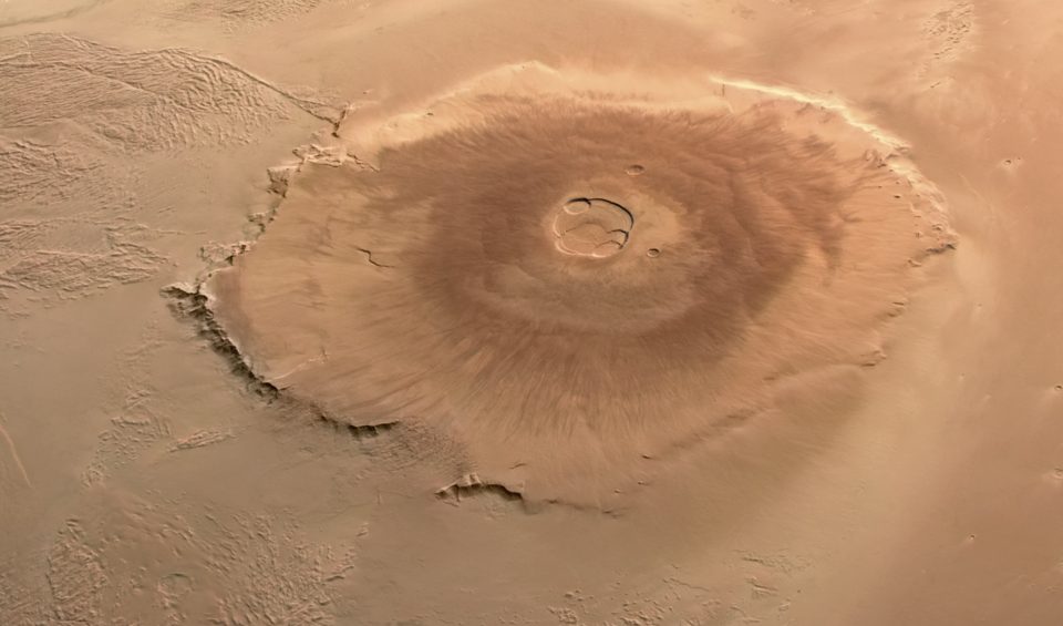 Illustration of Olympus Mons on Mars showing the tallest volcano in the Solar System with a vast volcanic landscape.