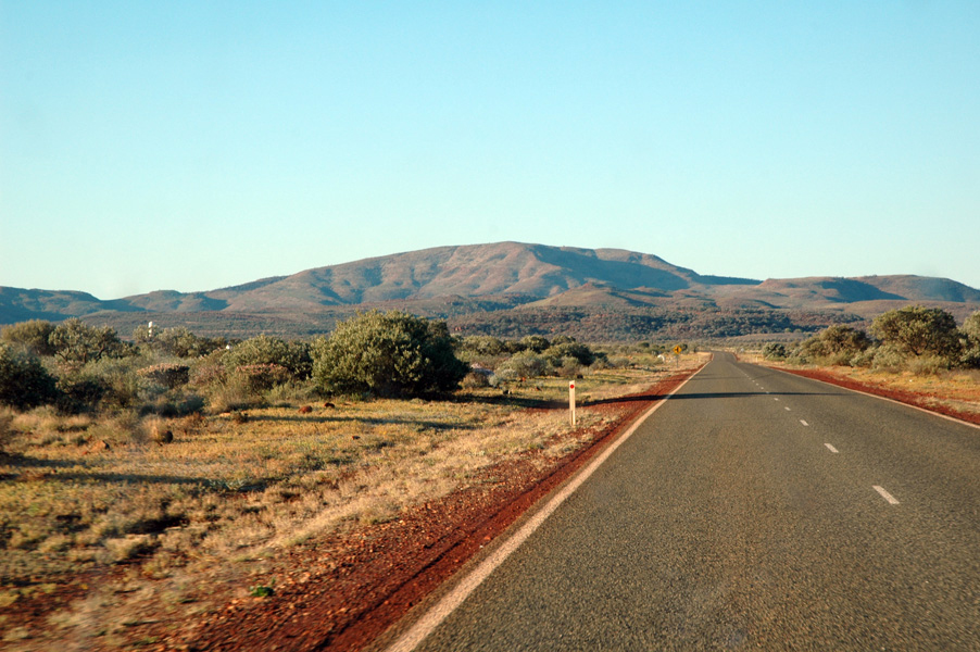 Hamersley Range in Western Australia showing ancient iron-rich rock formations, flat-topped plateaus, and rugged red landscapes shaped by billions of years of erosion.