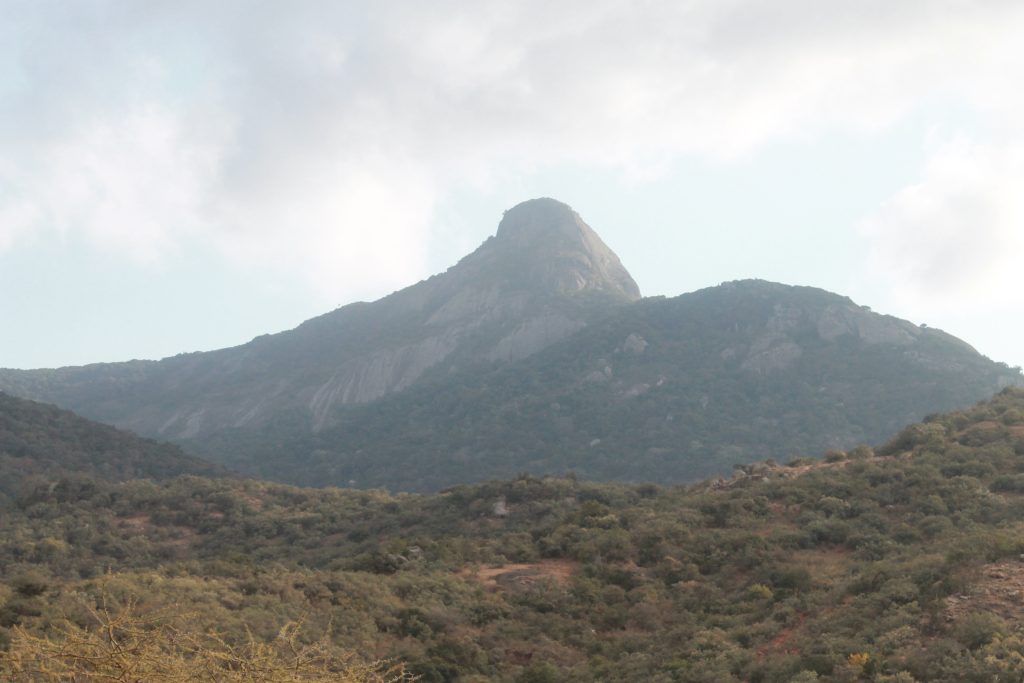 Longido Mountain in northern Tanzania with dry savannah landscapes, rocky slopes, and views toward Mount Kilimanjaro.