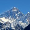 Mount Everest snow-covered peak rising above clouds in the Himalayas Nepal and China border