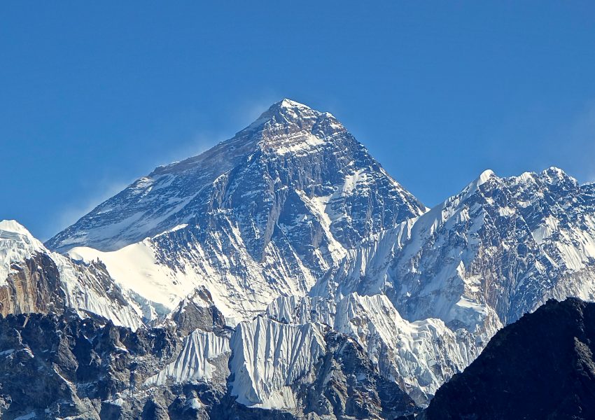 Mount Everest snow-covered peak rising above clouds in the Himalayas Nepal and China border