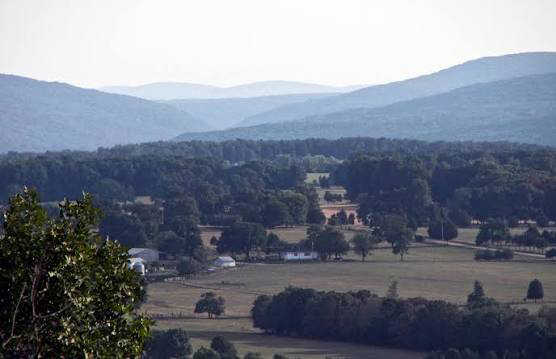 St. Francois Mountains in Missouri, USA showing ancient rounded hills, rocky outcrops, and forested terrain formed from very old volcanic rock.