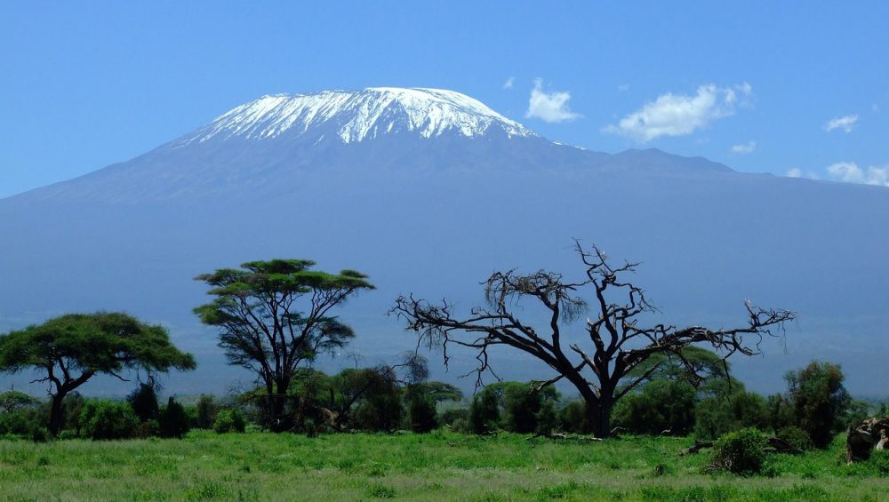 Climbers hiking on Mount Kilimanjaro with stunning mountain scenery, alpine landscape, and clear skies in Tanzania.