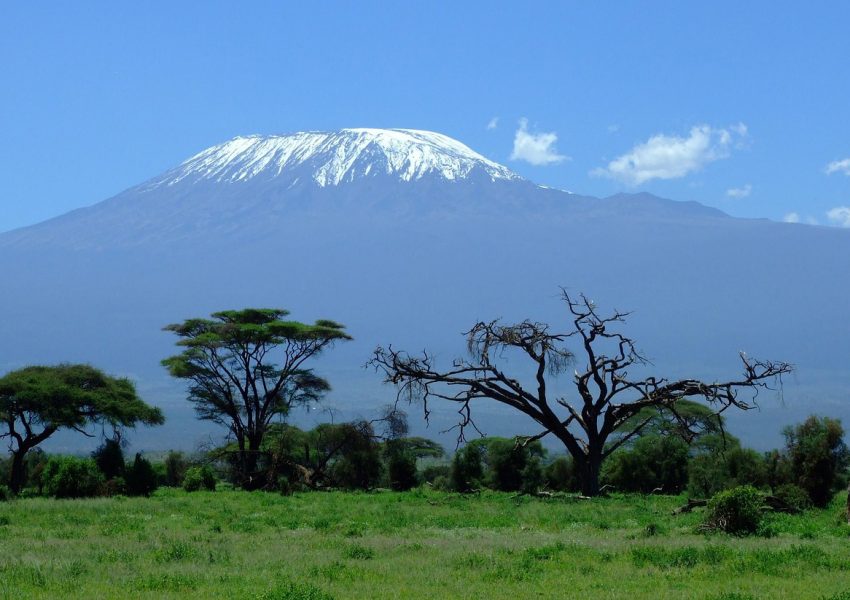Climbers hiking on Mount Kilimanjaro with stunning mountain scenery, alpine landscape, and clear skies in Tanzania.