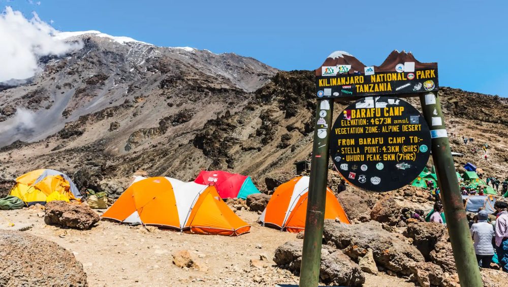 Barafu Camp sign standing among rocky terrain near the final summit route on Mount Kilimanjaro.