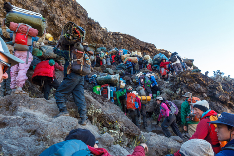 Trekking group eating morning breakfast at Barranco Camp on the Kilimanjaro climb