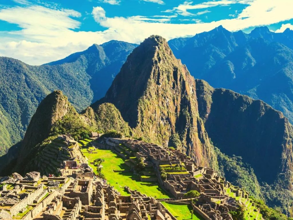 Inca Trail hiking path through Andes Mountains leading toward Machu Picchu in Peru with scenic mountain landscape.