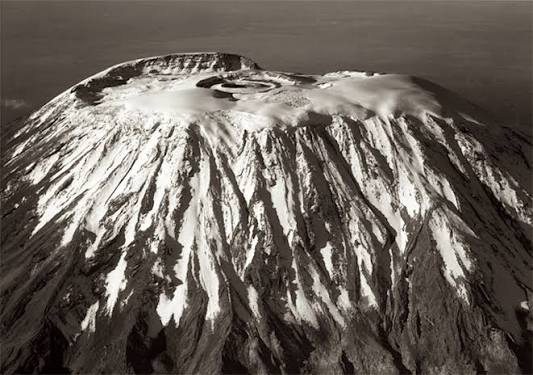 Inner crater inside Mount Kilimanjaro’s Kibo summit showing volcanic depression and rugged geological formations