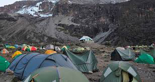 Climbers relaxing at a mountain campsite after a day of trekking