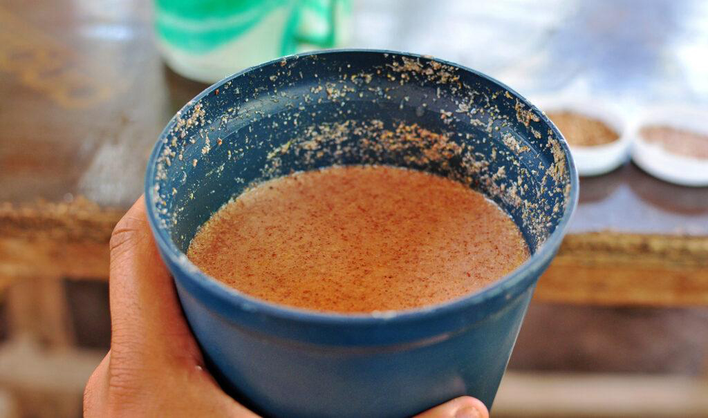 Traditional fermented banana beer served in a clay pot in Kilimanjaro
