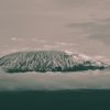 Hikers climbing the 8-Day Lemosho Route on Kilimanjaro through scenic landscapes toward Uhuru Peak summit.