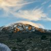 Climbers trekking Mount Kilimanjaro under clear dry season skies showing best time to climb Kilimanjaro.