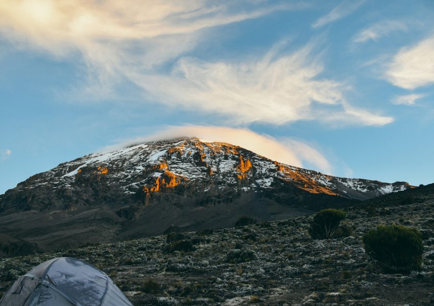 Climbers trekking Mount Kilimanjaro under clear dry season skies showing best time to climb Kilimanjaro.
