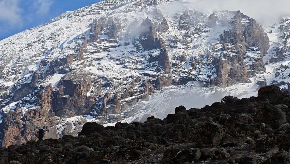 Lava Tower on Mount Kilimanjaro towering above alpine desert during Lemosho Route acclimatization hike with climbers today.