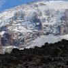 Lava Tower on Mount Kilimanjaro towering above alpine desert during Lemosho Route acclimatization hike with climbers today.