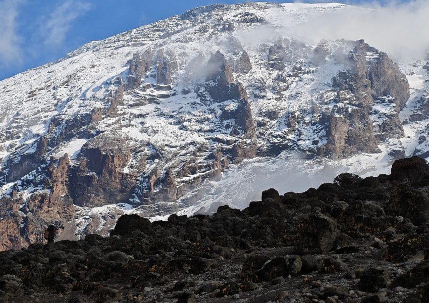 Lava Tower on Mount Kilimanjaro towering above alpine desert during Lemosho Route acclimatization hike with climbers today.