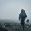 Budget climbers trekking Mount Kilimanjaro with local guides during an affordable and well-organized mountain expedition.