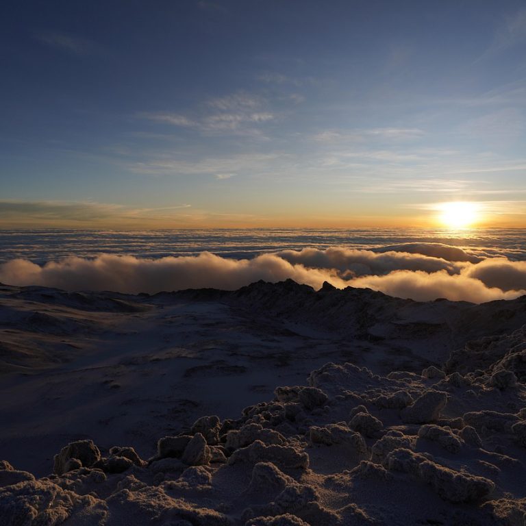 Kilimanjaro summit night climbers hiking under stars toward Uhuru Peak before sunrise on Mount Kilimanjaro