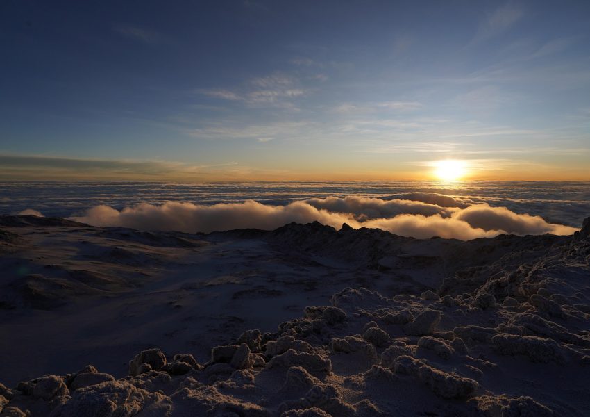 Kilimanjaro summit night climbers hiking under stars toward Uhuru Peak before sunrise on Mount Kilimanjaro
