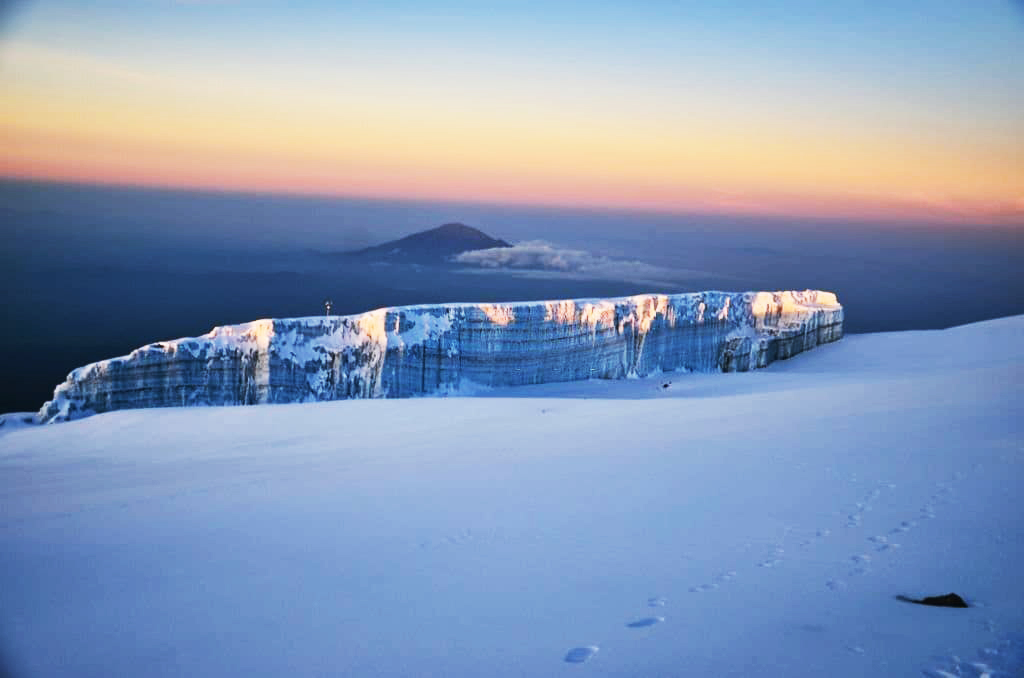 Kilimanjaro glaciers surrounding Uhuru Peak with towering ice fields on Africa's highest mountain summit at sunrise