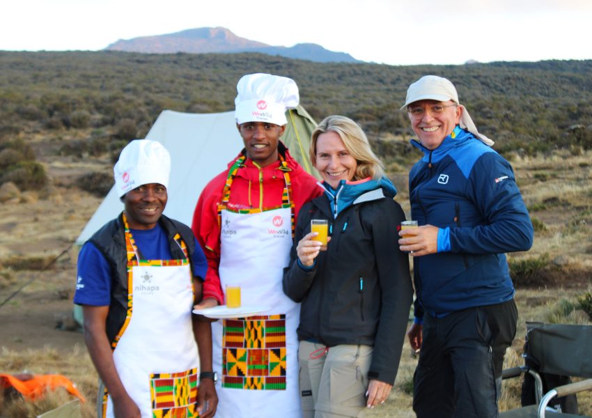 Client arrives at Kilimanjaro Shira Camp and enjoys fresh juice from the mountain crew.