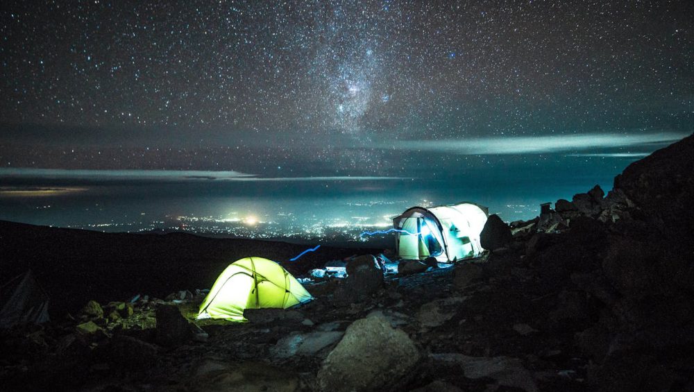 Full moon shining over Mount Kilimanjaro during a clear night summit climb in Tanzania