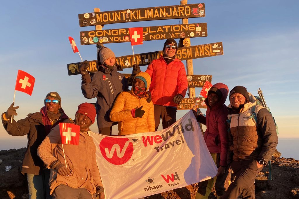 Climbers reaching Uhuru Peak summit on Mount Kilimanjaro in Tanzania